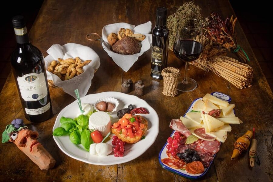 Basilicata: Discover volcanic tuff caves and taste excellent Lucanian wines - Four wines and a table full of local food