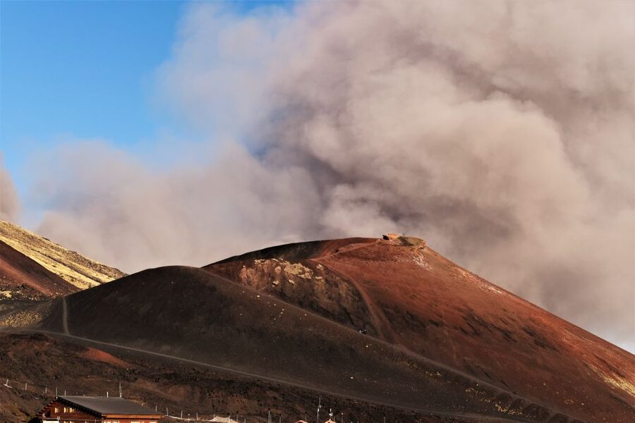 Catania: Etna Morning or Sunset Trek with Lava Tunnel & Gear - Entering the lava tunnel with a helmet and flashlight