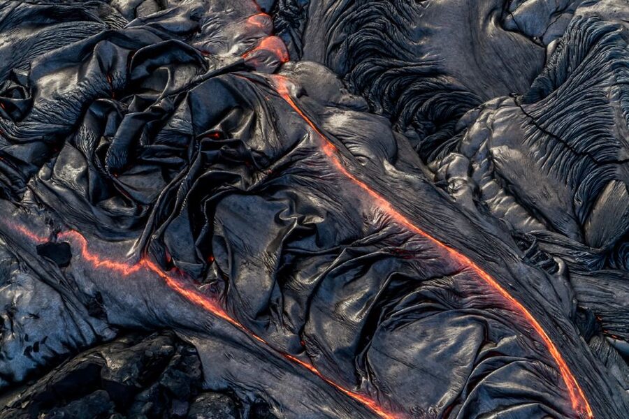 Hilo: Hawaii Volcanoes National Park Flight - Black sand beaches and lava reaching the sea