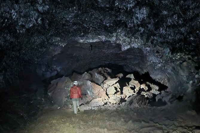 Lava Tunnel & Caving Adventure - Putting on safety gear underground