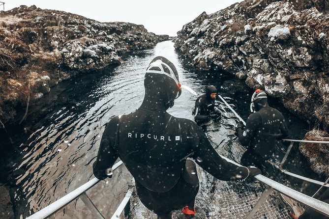 Lava Tunnel Caving & Snorkeling in Silfra with Transfer | Free Photos - Getting into the dry suit