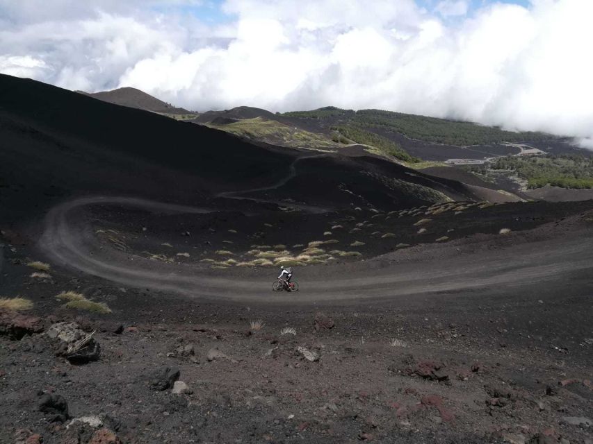 Mount Etna: Summit Cycling Tour - Following the dirt path through ancient craters