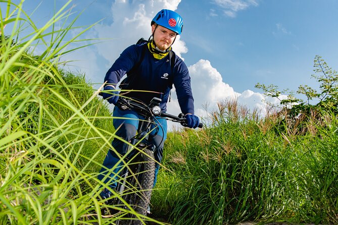 Private E-MTB guided cycling around Mt. Aso volcano & grasslands - Climbing through Aso’s open grasslands