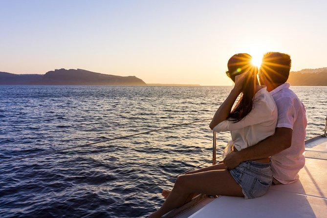 Shared Catamaran Romantic Sunset Cruise from Santorini via Volcano - Aspri Paralia and the pale volcanic coast